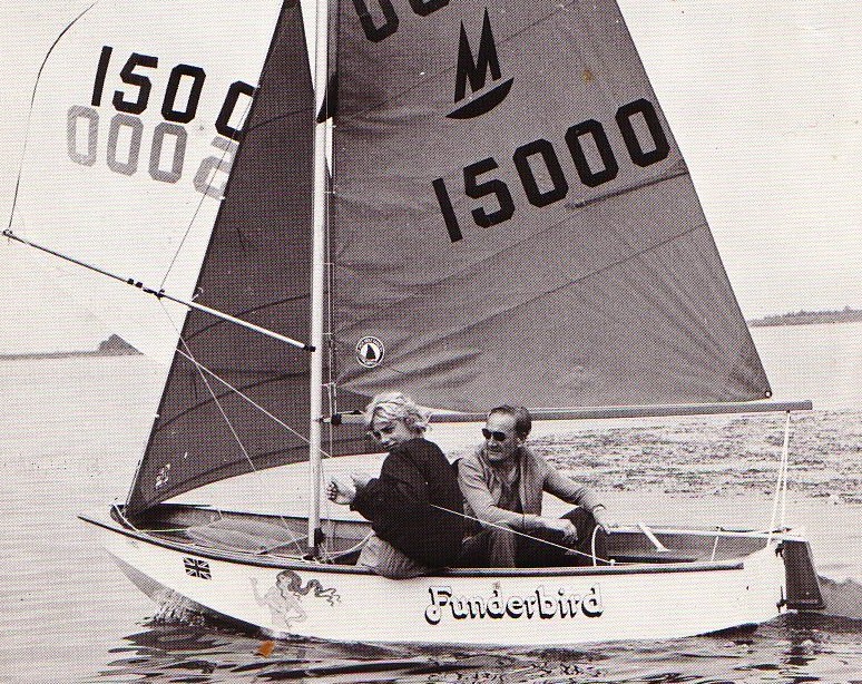 A white Mirror dinghy sailing with the spinnaker up
